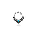 The Septum 925 Sterling Silver with Turquoise Stone by Kaya Movement is a bohemian fashion piece that showcases a circular design with intricate dot detailing along the lower curve and a small turquoise stone at the center. Made from 925 sterling silver, this unique septum jewelry for nose, tragus, and lobe is exquisitely presented against a white background.