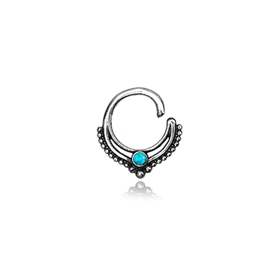 The Septum 925 Sterling Silver with Turquoise Stone by Kaya Movement is a bohemian fashion piece that showcases a circular design with intricate dot detailing along the lower curve and a small turquoise stone at the center. Made from 925 sterling silver, this unique septum jewelry for nose, tragus, and lobe is exquisitely presented against a white background.
