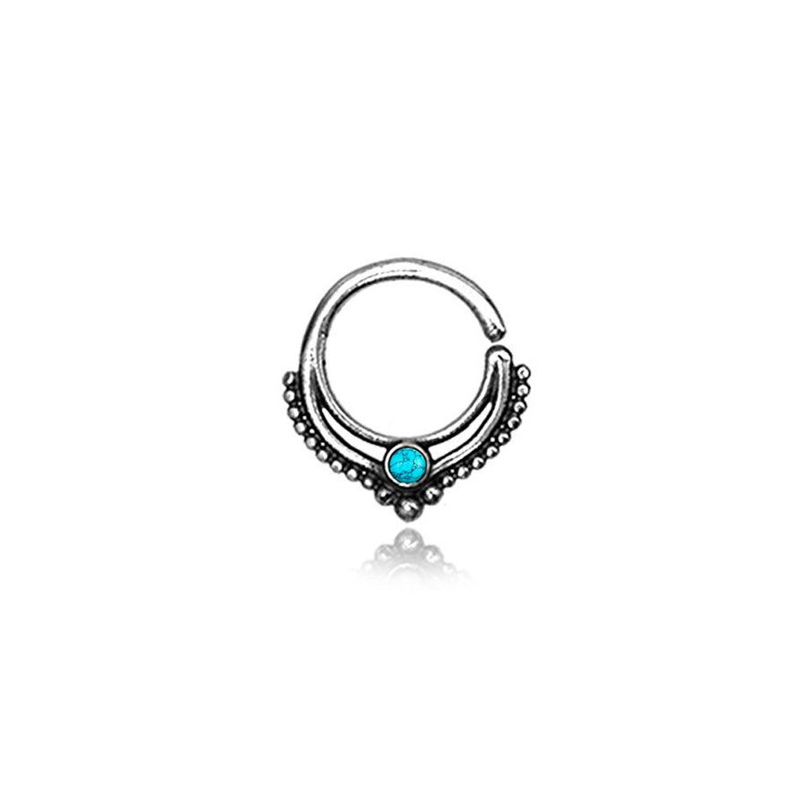 Introducing the Septum 925 Sterling Silver with Turquoise Stone - a bohemian alternative piece from Kaya Movement. This septum ring showcases a unique, authentic 1mm design embellished with a central turquoise stone and accented by small silver beads along the inner curve. Displayed against a plain white background, this exquisite jewelry effortlessly enhances your nose, tragus, or lobe.