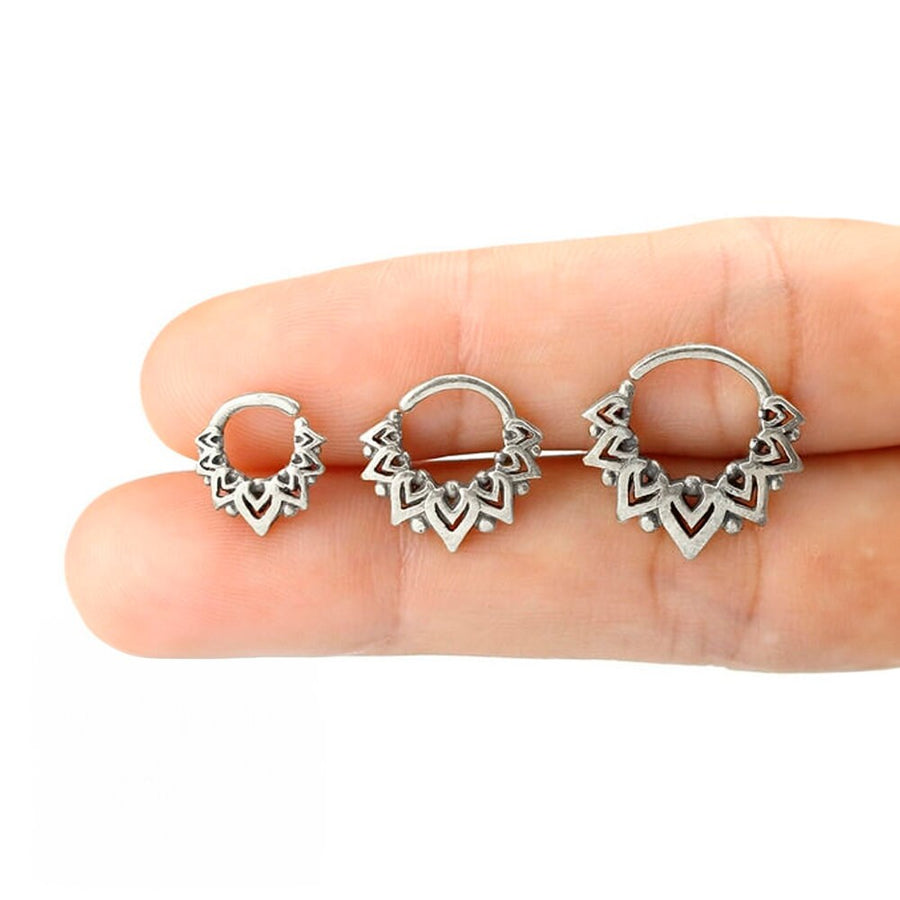 Close-up image of three tribal hoop earrings from Kaya Movement's LONA collection, featuring intricate Mandala designs. Displayed on a person's fingers for scale, the designs are progressively larger from left to right—each with detailed geometric patterns. The earrings have a stunning silver finish and come in diameters of 6mm, 8mm, and 10mm, perfect for Bohemian fashion aficionados looking for stylish nose, tragus, or lobe jewelry.