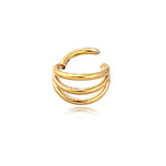 A gold ear cuff featuring a triple-band design and polished finish with an open-ended style that allows easy wear without the need for piercings. Set against a plain white background with a slight reflection, this piece perfectly complements minimalist collections, just like the Minimalist Gold PVD 316L Steel Septum "Trion" by Kaya Movement, known for its sleek triple-ring effect and subtle elegance with a 1.2mm thickness and 8mm diameter.