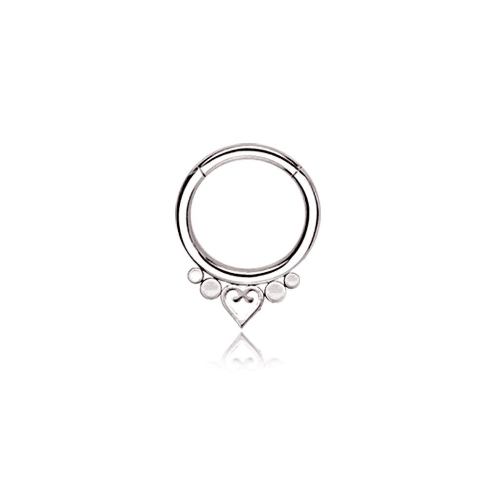 The Zuri Minimalist Mandala-Inspired Septum by Kaya Movement, crafted from silver 316L steel with a 1.2mm gauge and 8mm diameter, features a round design showcasing a symmetrical arrangement of small spheres and a stylized heart at the bottom center. This simple yet elegant piece exudes charm, set against a plain white background.