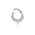 A silver circular nose ring with an intricate design featuring three small hearts along the lower edge, surrounded by a pattern of smaller circular shapes. The Aria Minimalist Mandala Septum by Kaya Movement is crafted from durable 316L steel with a silver finish, has a gauge of 1.2mm and diameter of 8mm, and is set against a white background. Perfect for tragus, lobe, or conch piercings.