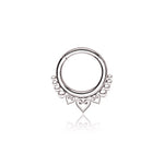 The Kaya Movement Aria Minimalist Mandala Septum in 316L Steel Silver Finish features an intricate design with small circular patterns on the sides and two inverted heart shapes below the central hoop. With a gauge of 1.2mm and an 8mm diameter, this septum ring is perfect for tragus, lobe, or conch piercings and offers a clean and elegant presentation against a white background.