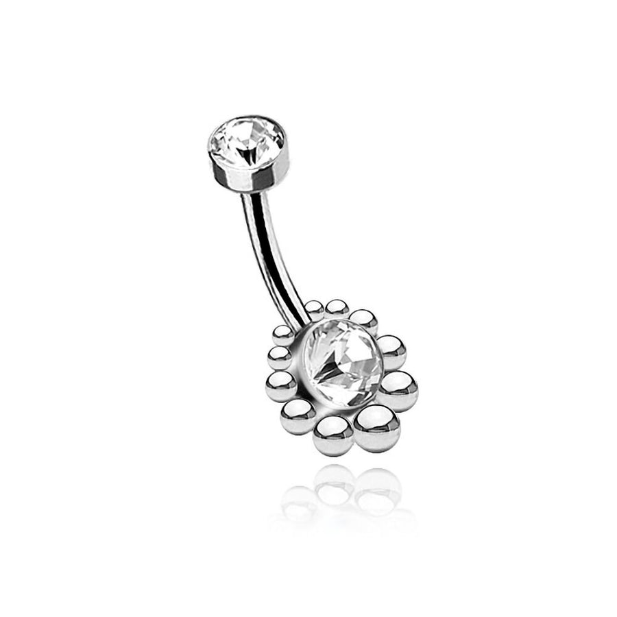 This stunning piece of navel jewelry, the Zirka Navel Jewelry - Boho Essence with Sparkling Zircon from Kaya Movement, is crafted from durable 316L surgical steel. Adorned with two clear gemstones, the smaller one embellishes the top while the larger oval gemstone at the bottom, encircled by small metal beads, beautifully reflects light and exudes natural bohemian elegance.