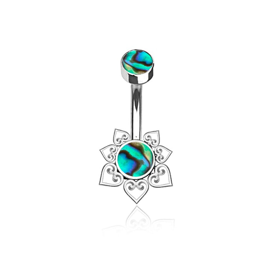 The Mandara Navel Piercing by Kaya Movement features a discreet hypoallergenic steel barbell with intricate heart-shaped cutout designs, adorned with vibrant green and blue abalone shell accents at both ends. This boho-chic mandala belly jewel is perfect for those seeking stylish navel jewelry.
