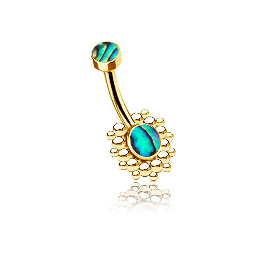 The Solis Navel Piercing by Kaya Movement features a geometric golden design, showcasing a vibrant, blue-green oval abalone shell set in delicate circular gold prongs. The stunning design includes a smaller matching stone at the top, connected by a curved gold bar. This boho shine adds an elegant and colorful appearance, perfect for navel piercings.