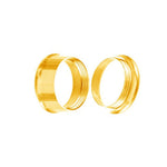 Two Zuri Tunnels by Kaya Movement, slightly offset and adjacent to each other, set against a white background. The ear plugs boast a smooth, polished surface with a Gold PVD finish that reflects light, accentuating their golden color. Crafted from 316L surgical steel, they epitomize minimalist jewelry elegance and are available in 6mm and 16mm sizes.