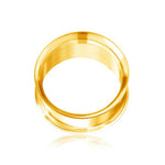 A polished gold ear plug with a smooth, reflective surface is shown against a white background. The Zuri Tunnel from Kaya Movement, crafted from 316L surgical steel with a Gold PVD finish, boasts a clean, minimalist design and is photographed from an elevated angle to highlight its circular shape and shiny finish.