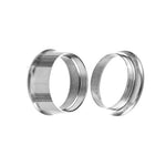 A close-up of two Kaya Movement Zura Tunnels, crafted from 316L surgical steel with a silver finish, positioned side by side against a plain white background. The ear plugs, available in diameters of 5mm and 14mm, showcase a minimalist design with a slight reflection on their surfaces.