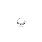 The Silver "Stera" Septum: Star's Glow by Kaya Movement is a minimalist ear cuff crafted in a semi-circular shape with pointed, spike-like accents around the outer edge. Designed for versatility, it can be worn on the nose, helix, tragus, lobe, or conch. This small 925 silver piece boasts a polished, reflective surface and is showcased against a plain white background.