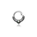 Introducing the Oparis Septum by Kaya Movement, crafted in 925 sterling silver. This unique and trendy piece features an open circular design with beaded detailing along the lower curve, accented with a central opal gemstone surrounded by a decorative border. Ideal for real nose piercings, this delicate and elegant Bohemian jewelry offers an alternative fashion statement with its 1mm gauge.