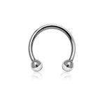 The 316L Steel Silvered Circular Barbell Septum "Argia" by Kaya Movement is a polished silver horseshoe-shaped piercing ring, available in 1.2mm gauge with diameters of 6mm, 8mm, and 10mm. It features two spherical beads at each end and boasts a shiny, reflective surface, set against a plain white background—an ideal piece for minimalist jewelry lovers and perfect for nose piercings as well as tragus and lobe adornments.