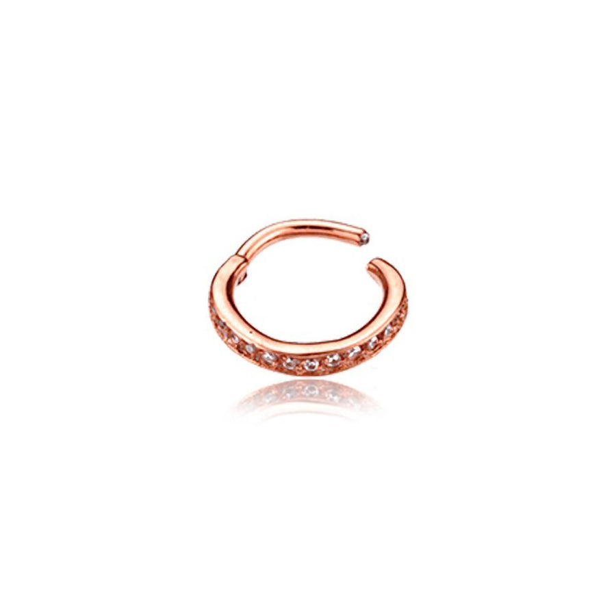The Hinged Septum Ring Clicker from Kaya Movement features a gold-toned hoop set with multiple small, clear gemstones along its outer curve. Reminiscent of a rose gold septum ring, this 16g cubic zirconia earring is designed with an open end that gives it a semi-circular shape and elegant appearance. Its sleek design is perfect for conch, daith, helix, cartilage, or rook piercings, and the reflection can be seen beneath it.