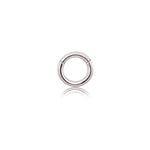 An elegant Aurel Simple Ear Ring by Kaya Movement, crafted from 316L steel with a shiny silver finish, features a minimalist design. Available in gauges of 2 or 3mm and diameters of 8, 10, 12, and 14mm, this small circular hoop earring includes a hinge at the top. Photographed against a white background with a subtle shadow beneath it, this piece exudes sophistication.