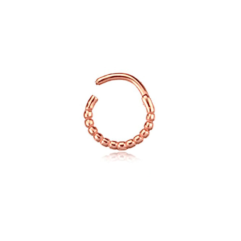 The Liora Elegant Septum by Kaya Movement features a stunning rose gold-tone design with a beaded detail on half of the circular ring, while the other half remains a smooth, unadorned metal arc. Photographed against a white background, this stainless steel 316L jewelry piece adds subtle shine and everyday elegance whether worn in the nose, tragus, or lobe. The septum measures 1.2mm thick and 8mm in diameter.