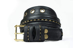 The ITO Punk Rock Men's Black Studded Leather Belt by Kaya Movement is displayed against a plain white background. This coiled belt, adorned with gold-tone studs and eyelets, features a gold metal buckle and decorative stitching detail along its length.